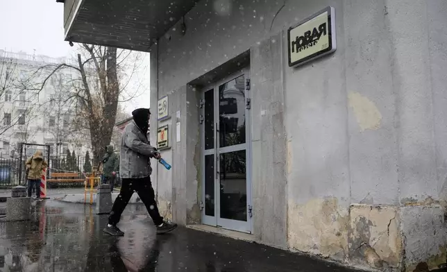 A man walks to enter a building where independent Russian newspaper Novaya Gazeta has an office in Moscow, Thursday, April 9, 2026. (AP Photo/Pavel Bednyakov)