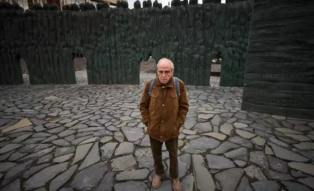 Jan Raczynski, chair of the International Memorial entity that was liquidated in Russia in 2021, stands after his interview with the Associated Press in front of the Wall of Grief memorial to the victims of Soviet repressions in Moscow, Wednesday, April 8, 2026. (AP Photo/Alexander Zemlianichenko)