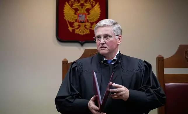Court judge Vyacheslav Kirillov reads a ruling to outlaw the "international movement" Memorial as extremist in a move against Nobel Peace Prize-winning rights group in Moscow, Russia, Thursday, April 9, 2026. (AP Photo/Alexander Zemlianichenko)