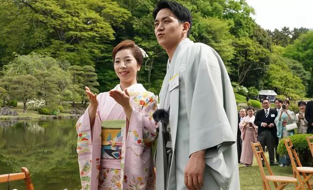 Japanese Olympic figure skating pairs champions Riku Miura, left, and Ryuichi Kihara attend a spring garden party hosted by Japan's Emperor Naruhito and Empress Masako at the Akasaka Palace's imperial garden in Tokyo, Friday, April 17, 2026. (Kazuhiro Nogi/Pool Photo via AP)