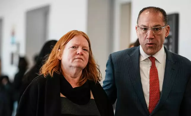Asa Ellerup, left, wife, of Rex Heuermann and Ellerup's attorney, Robert Macedonio, right, walk to the courtroom as Rex Heuermann, accused in Long Island's infamous Gilgo Beach serial killings, is expected to plead guilty, Wednesday, April 8, 2026, at Suffolk County Court in Riverhead, N.Y. (AP Photo/Eduardo Munoz Alvarez)