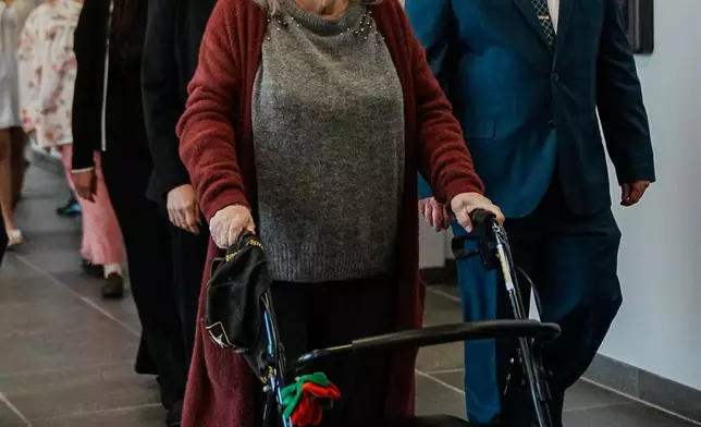 Elizabeth Baczkiel, mother of victim Jessica Taylor, walks to the courtroom as Rex Heuermann, accused in Long Island's infamous Gilgo Beach serial killings, is expected to plead guilty, Wednesday, April 8, 2026, at Suffolk County Court in Riverhead, N.Y. (AP Photo/Eduardo Munoz Alvarez)
