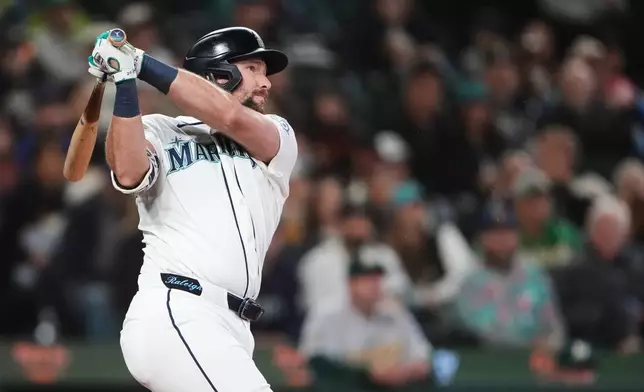 Seattle Mariners' Cal Raleigh follows through on a solo home run against the Athletics during the third inning of a baseball game, Wednesday, April 22, 2026, in Seattle. (AP Photo/Lindsey Wasson)