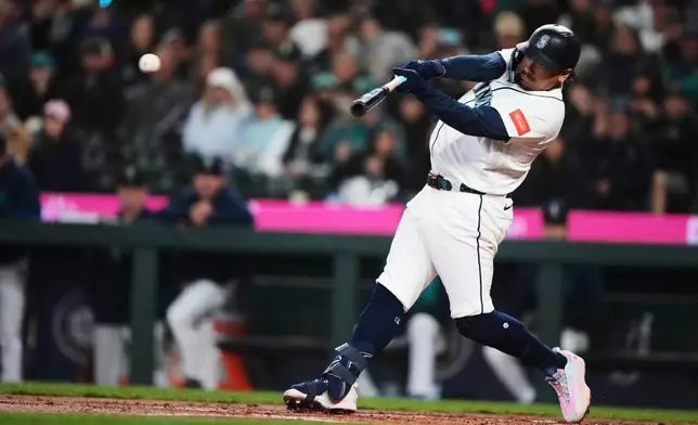 Seattle Mariners' Josh Naylor hits a single against the Athletics during the first inning of a baseball game, Wednesday, April 22, 2026, in Seattle. (AP Photo/Lindsey Wasson)