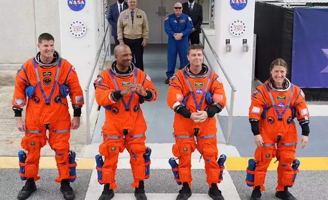 Astronauts, from left, Canadian Space Agency astronaut Jeremy Hansen, pilot Victor Glover, commander Reid Wiseman and mission specialist, Christina Koch leave the Operations and Checkout building on their way to Launch Pad 39B for a planned liftoff on NASA's Artemis II moon rocket at the Kennedy Space Center, Wednesday, April 1, 2026, in Cape Canaveral, Fla. (AP Photo/John Raoux)