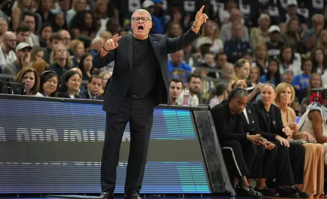 UConn head coach Geno Auriemma motions towards the court during the first half of a woman's NCAA college basketball tournament semifinal game between UConn and South Carolina at the Final Four, Friday, April 3, 2026, in Phoenix. (AP Photo/Rick Scuteri)