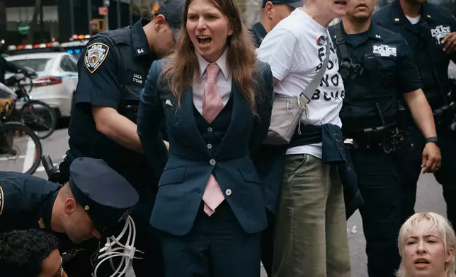Chelsea Manning, center, is arrested by police as protesters with Jewish Voice for Peace block traffic during a demonstration outside the New York office of U.S. Sen. Chuck Schumer, calling for an end to the U.S.-Israel war with Iran and opposing U.S. weapons support on Monday, April 13, 2026, in New York. (AP Photo/Andres Kudacki)