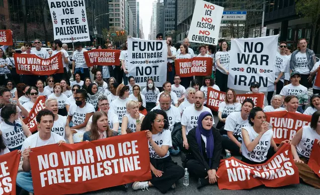 Chelsea Manning, bottom second left, and protesters with Jewish Voice for Peace block traffic during a demonstration outside the New York office of U.S. Sen. Chuck Schumer, calling for an end to the U.S.-Israel war with Iran and opposing U.S. weapons support, Monday, April 13, 2026, in New York. (AP Photo/Andres Kudacki)