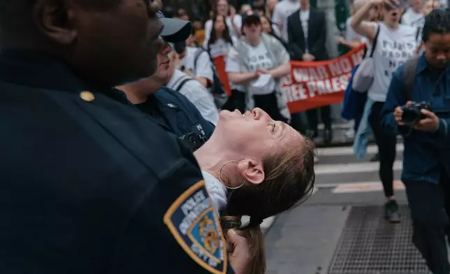 A protester with Jewish Voice for Peace is arrested after blocking traffic during a demonstration outside the New York office of U.S. Sen. Chuck Schumer, calling for an end to the U.S.-Israel war with Iran and opposing U.S. weapons support on Monday, April 13, 2026, in New York. (AP Photo/Andres Kudacki)