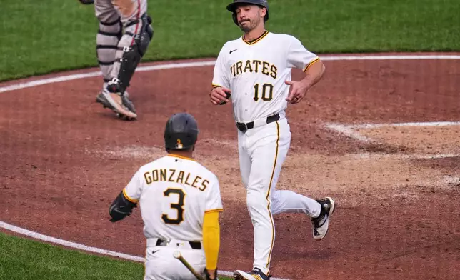 Pittsburgh Pirates' Bryan Reynolds (10) scores on a sacrifice fly hit by Pittsburgh Pirates' Spencer Horwitz off Baltimore Orioles pitcher Shane Baz during the fourth inning of a baseball game in Pittsburgh, Saturday, April 4, 2026. (AP Photo/Gene J. Puskar)