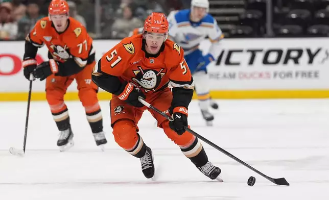 Anaheim Ducks defenseman Olen Zellweger (51) brings the up puck up the ice during the third period of an NHL hockey game against the St. Louis Blues Friday, April 3, 2026, in Anaheim, Calif. (AP Photo/Gregory Bull)