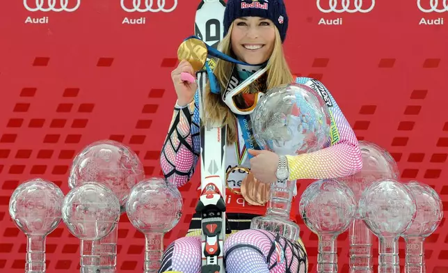 FILE - FILE - Lindsey Vonn, of the United States, poses with all the Olympic medals and Women's World Cup skiing trophies she has won in her career, on March 13, 2010, in Garmisch-Partenkirchen, Germany. (AP Photo/Giovanni Auletta, File)