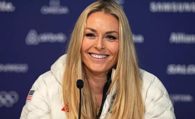 FILE - United States' Lindsey Vonn smiles during a press conference by the U.S. ski team at the 2026 Winter Olympics, in Cortina d'Ampezzo, Italy, Tuesday, Feb. 3, 2026. (AP Photo/Fatima Shbair, File)