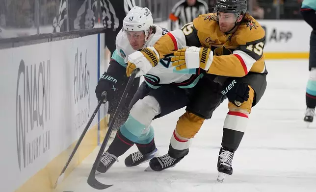Seattle Kraken defenseman Ryker Evans (41) skates against Vegas Golden Knights defenseman Noah Hanifin (15) during the first period of an NHL hockey game Wednesday, April 15, 2026, in Las Vegas. (AP Photo/John Locher)