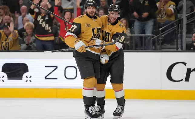 Vegas Golden Knights defenseman Shea Theodore (27) celebrates after scoring against the Seattle Kraken during the second period of an NHL hockey game Wednesday, April 15, 2026, in Las Vegas. (AP Photo/John Locher)