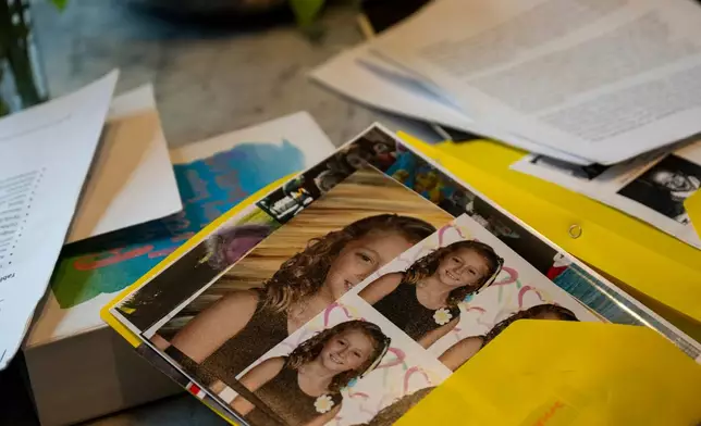Kate goes through folders of writings and photographs from her time at Unita Academy and other residential programs in her apartment in Kentucky, Wednesday, Dec. 10, 2025. (AP Photo/Michael Swensen)