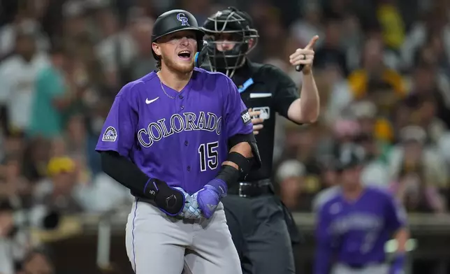 Colorado Rockies' Hunter Goodman (15) holds hand after getting hit by a pitch while batting during the sixth inning of a baseball game against the San Diego Padres Thursday, April 9, 2026, in San Diego. (AP Photo/Gregory Bull)
