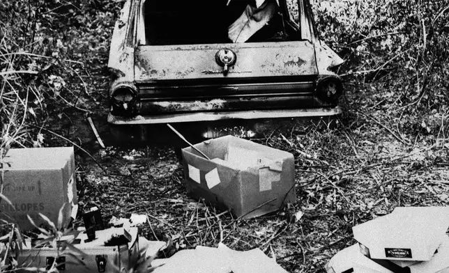 FILE - The burned station wagon of three missing civil rights workers, Michael Schwerner, Andrew Goodman, and James Chaney, in a swampy area near Philadelphia, Miss., June 24, 1964. The bodies of the men were found later in an earthen dam. (AP Photo/Jack Thornell, File)