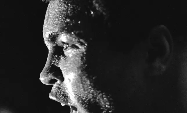 FILE - The face of Muhammad Ali is covered in perspiration after a workout, Sept. 8, 1978 in New Orleans where he is getting ready for his rematch will Leon Spinks for the title. (AP Photo/Jack Thornell, File)