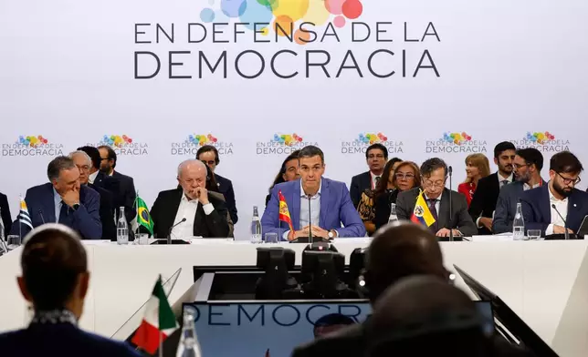 Spain's Prime Minister Pedro Sanchez, center, Brazil's President Luiz Inacio Lula da Silva, center left, Colombia's President Gustavo Petro, second right, Uruguay's President Yamandu Orsi, left, and Chile's former President Gabriel Boric, right, attend the Meeting in Defence of Democracy summit in Barcelona, Spain, Saturday, April 18, 2026. (AP Photo/Joan Monfort)