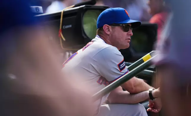 New York Mets manager Carlos Mendoza stands stands in the dugout during the fifth inning of a baseball game against the Chicago Cubs, Friday, April 17, 2026, in Chicago. (AP Photo/Erin Hooley)