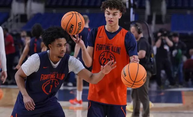 Illinois' Brandon Lee (1) knocks the ball away from teammate Keaton Wagler, right, during practice ahead of a national semifinal NCAA college basketball tournament game against UConn at the Final Four, Friday, April 3, 2026, in Indianapolis. (AP Photo/Michael Conroy)