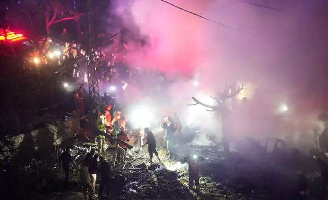 Rescue workers inspect the scene of Israeli airstrikes, in Beirut, Lebanon, Wednesday, April 1, 2026. (AP Photo/Hussein Malla)