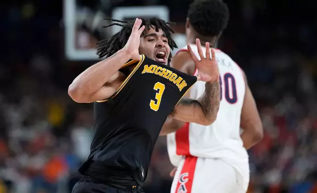 Michigan guard Elliot Cadeau (3) celebrates a basket against Arizona during the second half of an NCAA college basketball tournament semifinal game at the Final Four, Saturday, April 4, 2026, in Indianapolis. (AP Photo/Abbie Parr)