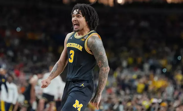 Michigan's Elliot Cadeau reacts during the first half of an NCAA college basketball tournament semifinal game against Arizona at the Final Four, Saturday, April 4, 2026, in Indianapolis. (AP Photo/Michael Conroy)