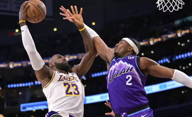 Los Angeles Lakers forward LeBron James (23) goes up to shoot over Utah Jazz forward Blake Hinson (2) for a basket during the first half of an NBA basketball game Sunday, April 12, 2026, in Los Angeles. (AP Photo/Jayne Kamin-Oncea)