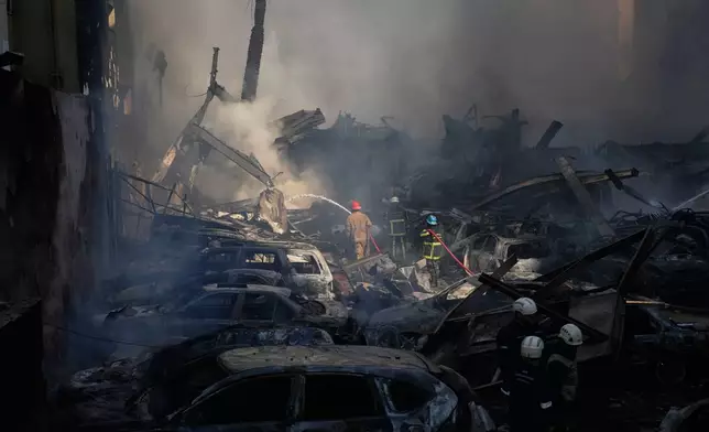 Firefighters spray smoldering debris at the site of an Israeli airstrike that struck a building in Beirut, Lebanon, Wednesday, April 8, 2026. (AP Photo/Hassan Ammar)