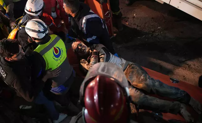 Rescuers carry an injured man from a destroyed building that was hit in an Israeli airstrike in central Beirut, Lebanon, Wednesday, April 8, 2026. (AP Photo/Emilio Morenatti)
