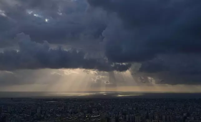 Heavy clouds cover Dahiyeh, Beirut's southern suburbs, at sunset in Lebanon, Thursday, April 9, 2026. (AP Photo/Bilal Hussein)