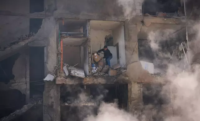 A man gathers his belongings from his home, which has been destroyed in an Israeli airstrike a day earlier in Beirut, Lebanon, Thursday, April 9, 2026. (AP Photo/Emilio Morenatti)