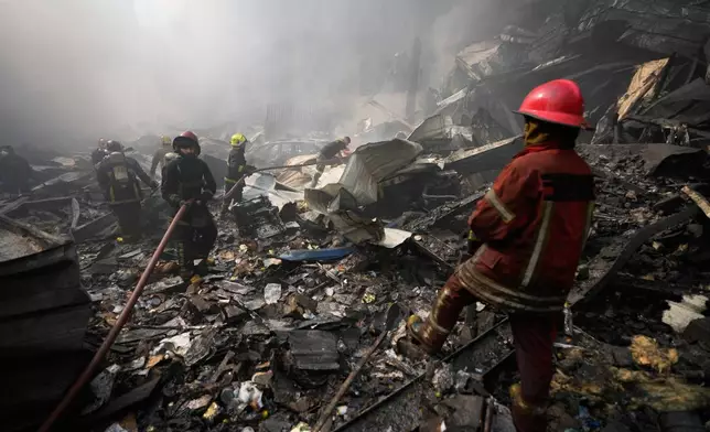 Firefighters extinguish a fire at the site of an Israeli airstrike in Beirut, Lebanon, Wednesday, April 8, 2026. (AP Photo/Hussein Malla)