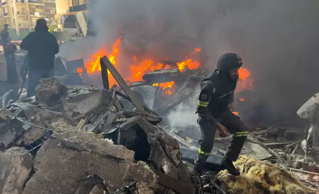 Rescuers gather at the site of an Israeli airstrike in central Beirut, Lebanon, Wednesday, April 8, 2026. (AP Photo/Hussein Malla)