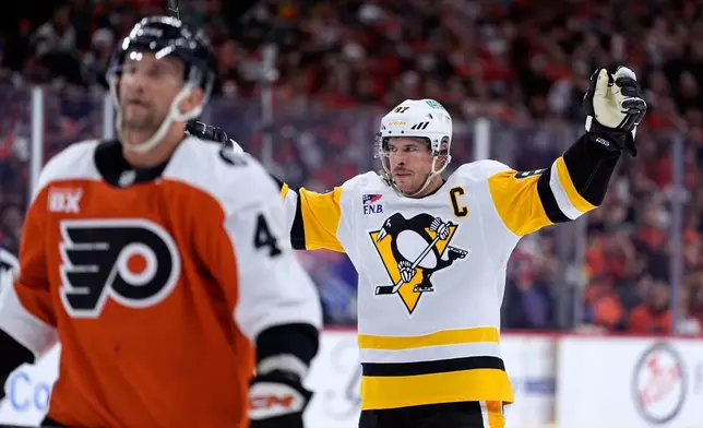Pittsburgh Penguins' Sidney Crosby, right, reacts behind Philadelphia Flyers' Luke Glendening after scoring during the first period of Game 4 in the first round of the NHL Stanley Cup hockey playoff series Saturday, April 25, 2026, in Philadelphia. (AP Photo/Matt Slocum)
