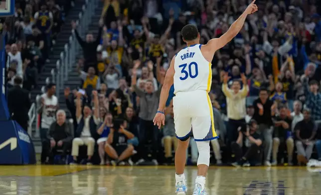 Golden State Warriors guard Stephen Curry celebrates after making a 3-point basket during the first half of an NBA basketball game against the Houston Rockets, Sunday, April 5, 2026, in San Francisco. (AP Photo/Godofredo A. Vásquez)