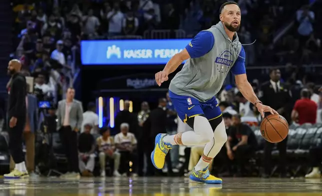 Golden State Warriors guard Stephen Curry warms up before an NBA basketball game against the Houston Rockets, Sunday, April 5, 2026, in San Francisco. (AP Photo/Godofredo A. Vásquez)