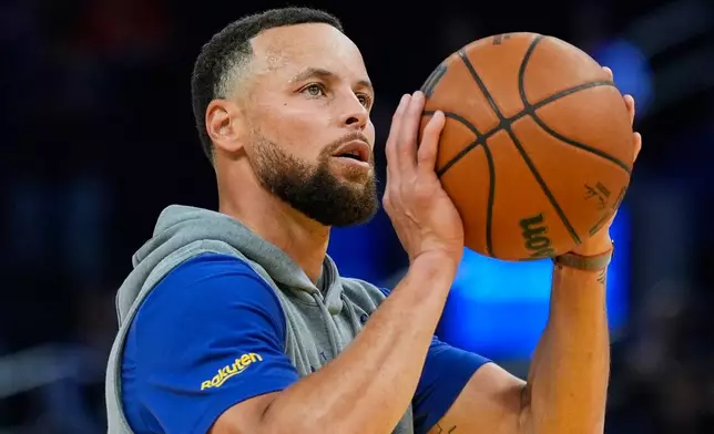 Golden State Warriors guard Stephen Curry warms up before an NBA basketball game against the Houston Rockets, Sunday, April 5, 2026, in San Francisco. (AP Photo/Godofredo A. Vásquez)