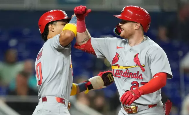 St. Louis Cardinals' Nathan Church, right, celebrates with Masyn Winn, after hitting a two-run home run to bring them both home during the fourth inning of a baseball game against the Miami Marlins, Tuesday, April 21, 2026, in Miami. (AP Photo/Rebecca Blackwell)