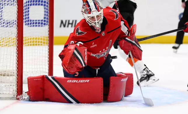 Washington Capitals goaltender Logan Thompson (48) stops the puck during the second period of an NHL hockey game against the Philadelphia Flyers, Tuesday, March 31, 2026, in Washington. (AP Photo/Nick Wass)