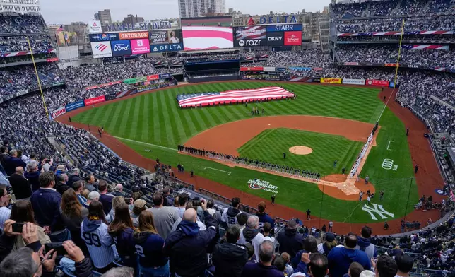 An American flag is displayed in the outfield before the New York Yankees' home-opener baseball game against the Miami Marlins, Friday, April 3, 2026, in New York. (AP Photo/Yuki Iwamura)