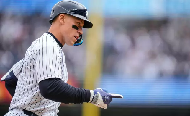 New York Yankees' Aaron Judge (99) celebrates after hitting a two-run home run during the first inning of the Yankees' home-opener baseball game against the Miami Marlins, Friday, April 3, 2026, in New York. (AP Photo/Yuki Iwamura)