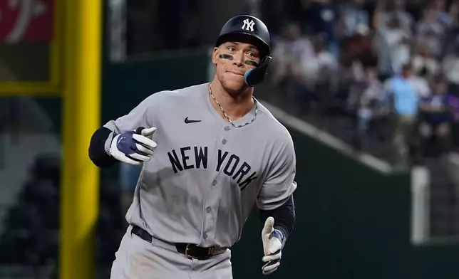 New York Yankees' Aaron Judge rounds the bases after hitting a solo home run off of Texas Rangers relief pitcher Cole Winn in the ninth inning of a baseball game Tuesday, April 28, 2026, in Arlington, Texas. (AP Photo/Tony Gutierrez)