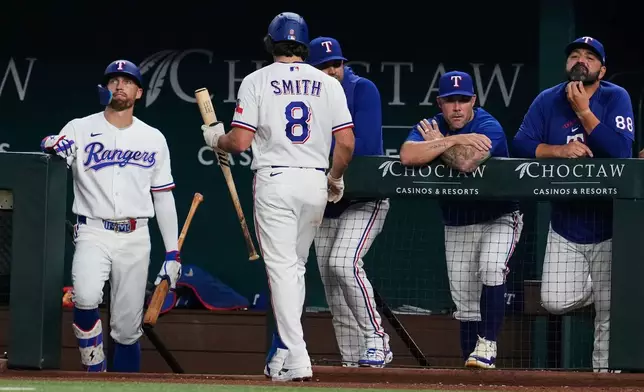 Texas Rangers' Josh Smith (8) walks to the dugout after striking out in the fifth inning of a baseball game against the New York Yankees Tuesday, April 28, 2026, in Arlington, Texas. (AP Photo/Tony Gutierrez)