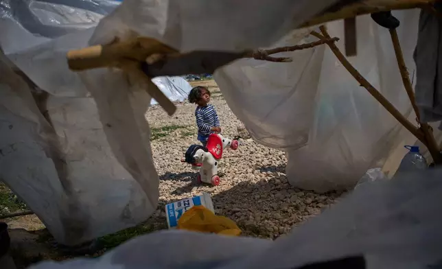 Ali, 4, holds a toy horse next to the tent his family uses as a shelter after fleeing Israeli bombardment in southern Lebanon, in Beirut, Lebanon, Wednesday, April 8, 2026. (AP Photo/Emilio Morenatti)