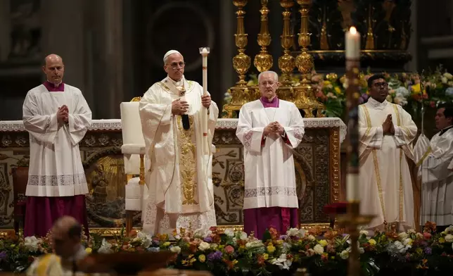Pope Leo XIV leads the Easter Vigil inside St. Peter's Basilica at The Vatican, Saturday, April 4, 2026. (AP Photo/Andrew Medichini)