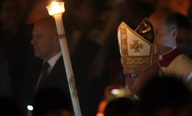 Pope Leo XIV arrives for the Easter Vigil inside St. Peter's Basilica at The Vatican, Saturday, April 4, 2026. (AP Photo/Andrew Medichini)