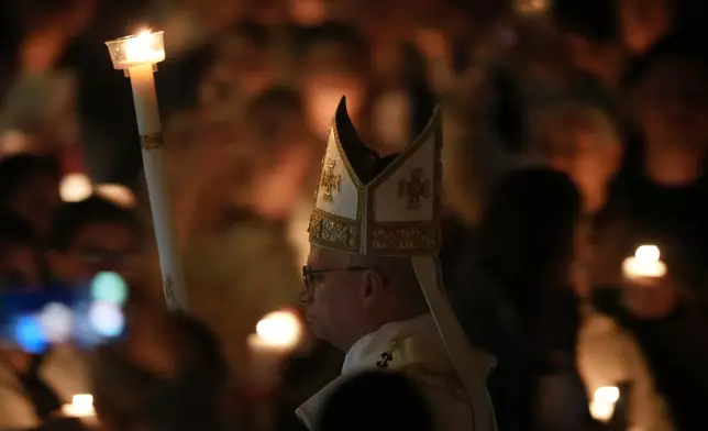 Pope Leo XIV arrives for the Easter Vigil inside St. Peter's Basilica at The Vatican, Saturday, April 4, 2026. (AP Photo/Andrew Medichini)